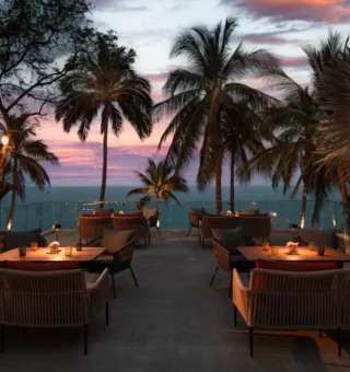Beachfront terrace dining at sunset at Anantara Hua Hin Resort