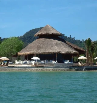 Thatched beach pavilion seen from the sea at The Blue Sky Resort Koh Payam
