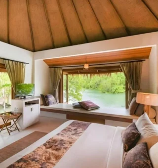 Bedroom with picture window onto mangroves at The Blue Sky Resort Koh Payam