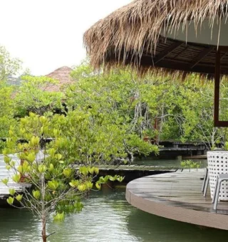Wooden boardwalk to a lagoon villa at The Blue Sky Resort Koh Payam