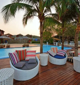 Poolside lounge chairs and colorful cushions at The Blue Sky Resort Koh Payam