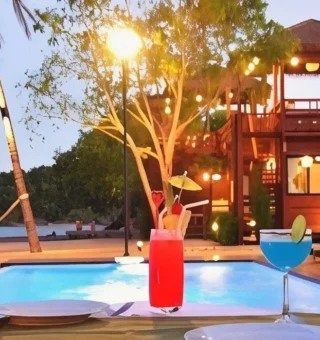 Cocktails by the pool at sunset at The Blue Sky Resort Koh Payam
