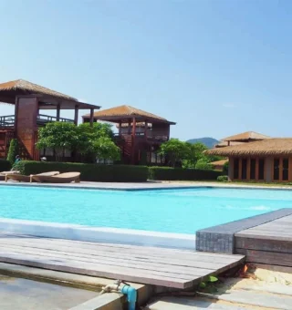 Pool deck with wooden beach villas at The Blue Sky Resort Koh Payam