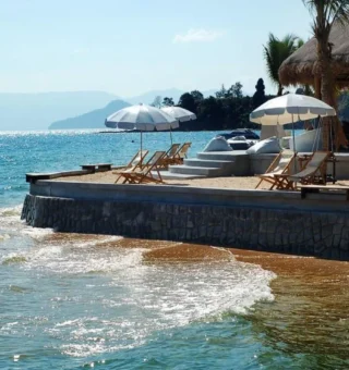 Seaside sun deck with umbrellas at The Blue Sky Resort Koh Payam