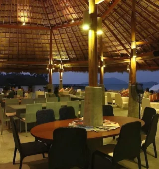 Restaurant dining room at dusk at The Blue Sky Resort Koh Payam