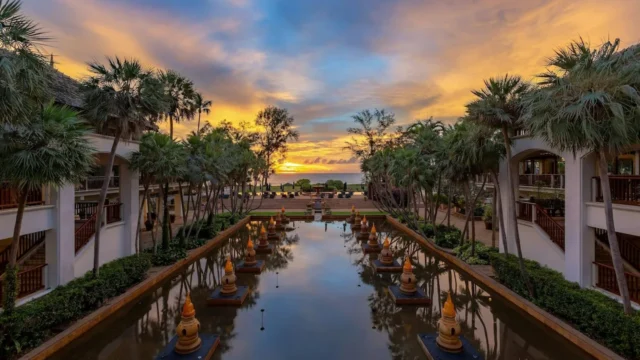 Reflection pond and palms at sunset at JW Marriott Phuket Resort & Spa