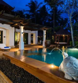 Pool villa with turtle fountain at night at JW Marriott Phuket Resort & Spa
