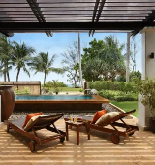 Garden terrace with loungers near the beach at JW Marriott Phuket Resort & Spa