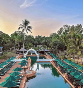 Main pool lined with green umbrellas at JW Marriott Phuket Resort & Spa