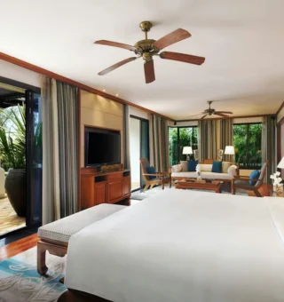 Suite bedroom opening onto a pool terrace at JW Marriott Phuket Resort & Spa