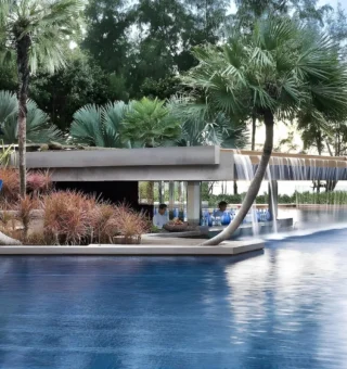 Infinity pool and sala surrounded by palms at JW Marriott Phuket Resort & Spa