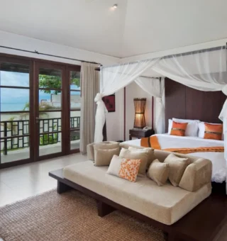Four-poster bedroom with ocean view at The Villas by Kanda Residences
