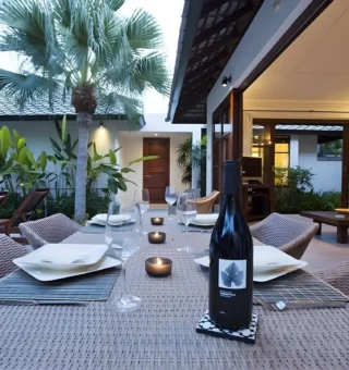 Poolside table set for dinner at The Villas by Kanda Residences