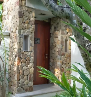 Stone-clad villa entrance in the garden at The Villas by Kanda Residences