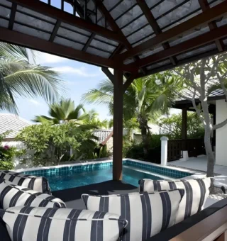 Shaded sala with daybed beside the pool at The Villas by Kanda Residences