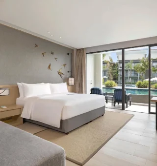 Larger Guest room, 1 King, Sofa bed, Pool access - Bed at Le Meridien Khao Lak Resort & Spa