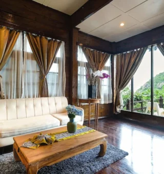 Mountain chalet living room with floor-to-ceiling windows at Nangyuan Island Dive Resort