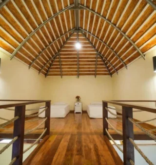 Vaulted timber loft bedroom in a villa at Nangyuan Island Dive Resort