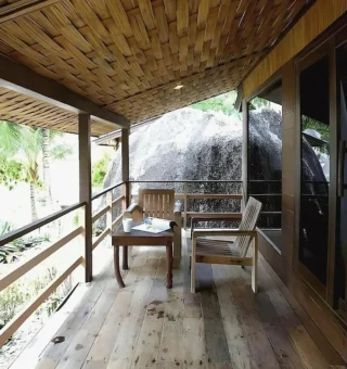 Wooden veranda outside a garden room at Nangyuan Island Dive Resort