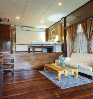 Mountain chalet interior with lounge and dining area at Nangyuan Island Dive Resort