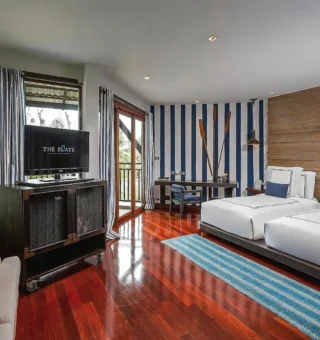 Twin room with striped accents and timber walls at The Slate Phuket