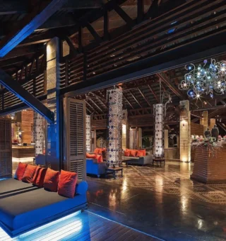 Lobby lounge lit in blue with sculptural chandelier at The Slate Phuket