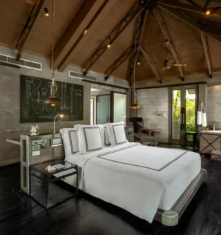 Pool villa bedroom with vaulted ceiling at The Slate Phuket
