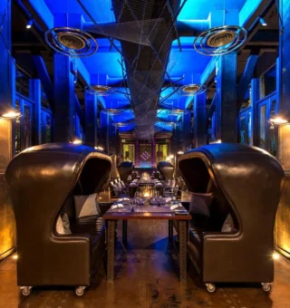 Restaurant with high-backed leather booth seats at The Slate Phuket