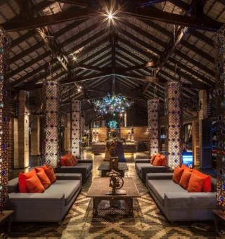 Lounge with mosaic lanterns and orange cushions at The Slate Phuket