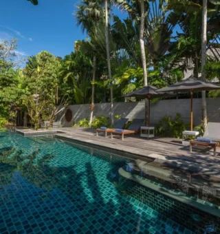 Garden pool surrounded by tropical plants at The Slate Phuket