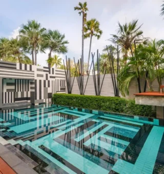 Geometric pool with black and white mural wall at The Slate Phuket